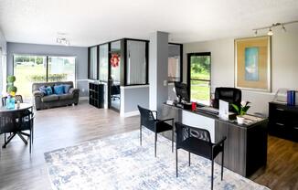 the view of a living room with a desk and a couch