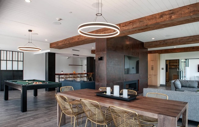 a dining room with a table and a pool table