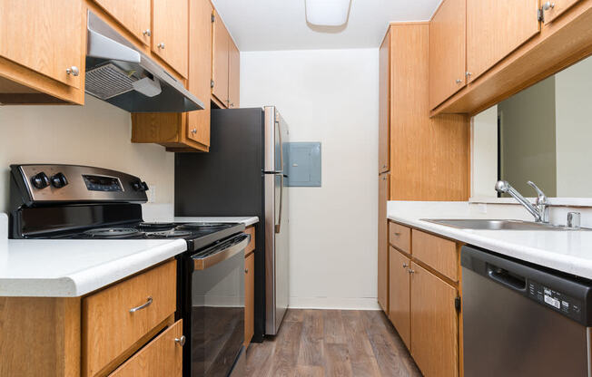 a kitchen with a stove refrigerator and sink