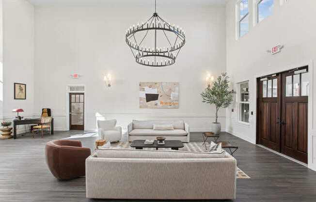 A living room with a grey sofa and a wooden floor.