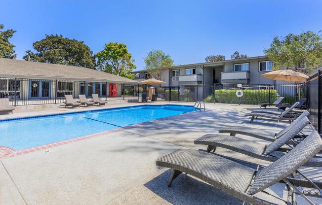 a group of lawn chairs sitting on top of a beach