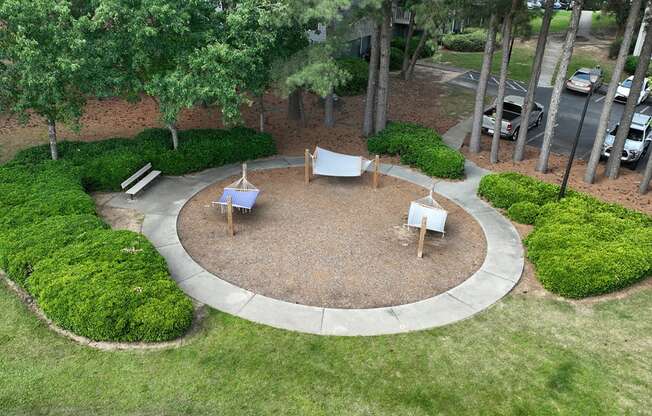 an aerial view of a backyard with a fire pit and a seating area