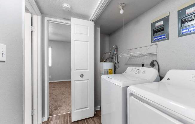 A white bathroom with a washer and dryer.