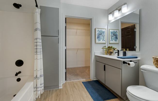 a bathroom with a sink toilet and shower in a 555 waverly unit