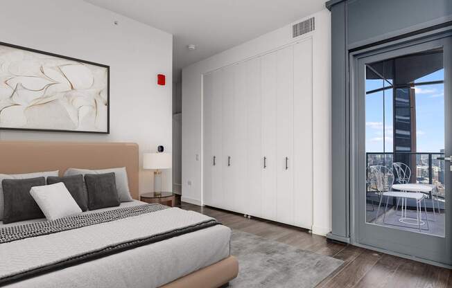 a bedroom with a bed and a sliding glass door to a balcony at Cassidy on Canal, Chicago, 60606