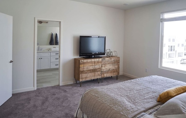 a bedroom with a bed and a television on a dresser at Novella Biltmore, Arizona, 85016