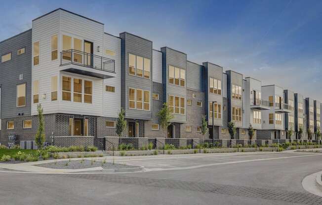 A row of modern townhouses with balconies and garages. at Reveal, Draper, UT, 84020