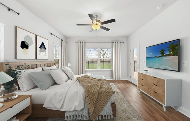 a bedroom with a large bed and a ceiling fan