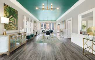 a living room with a teal ceiling and white walls