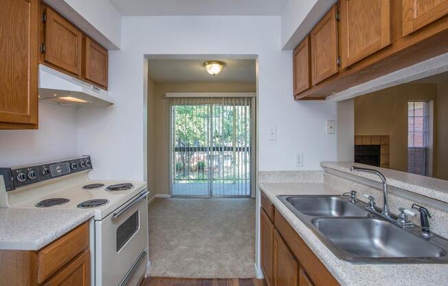 a kitchen with a stove a sink and a window