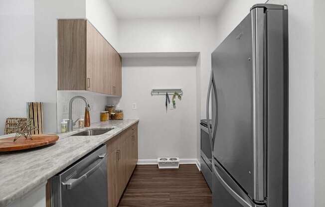 A modern kitchen with a refrigerator on the right.