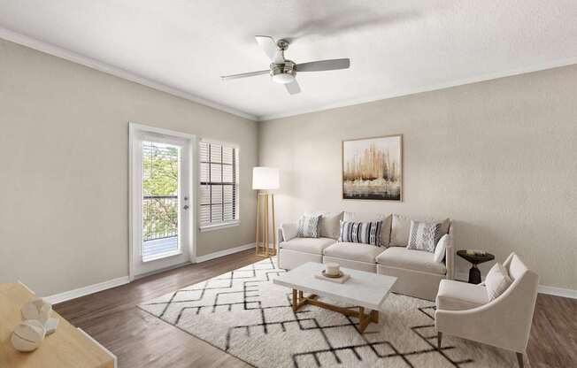 A living room with a white couch, a coffee table, and a ceiling fan.