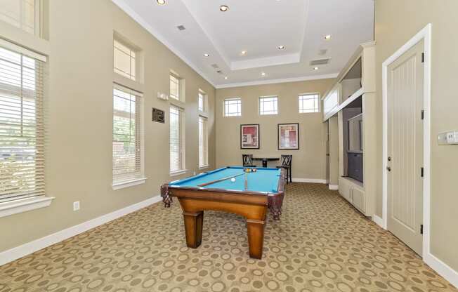 a game room with a pool table and a television