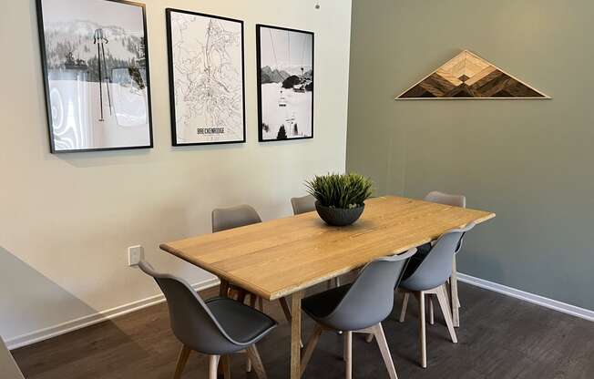 a dining room with a wooden table and grey chairs
