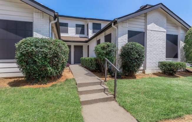 a view of the exterior of a building at the whispering winds apartments in pearland, tx