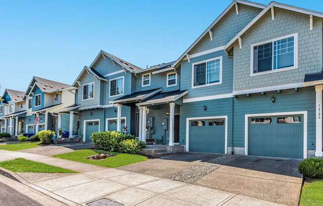 A row of townhomes with blue and grey exteriors at The Landing Apartments and Townhomes, Oregon, 97045