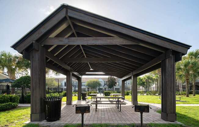 a pavilion with benches in a park