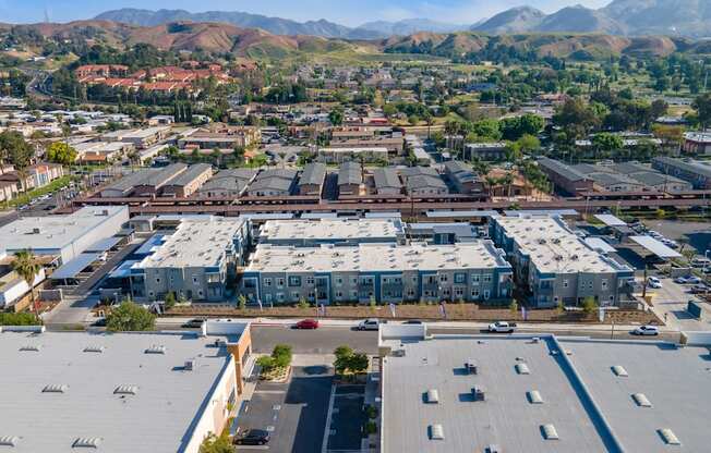 an aerial view of a large industrial park with rows of buildings and hills in the background at Loma Villas Apartments, San Bernardino