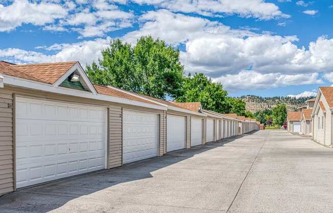 a long row of garages with white garage doors
