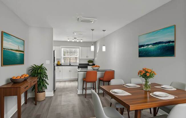 A dining room with a wooden table set for four at Mandarin Bay Apartments.