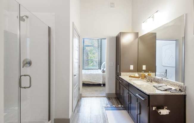 a bathroom with a shower and a sink and a mirror