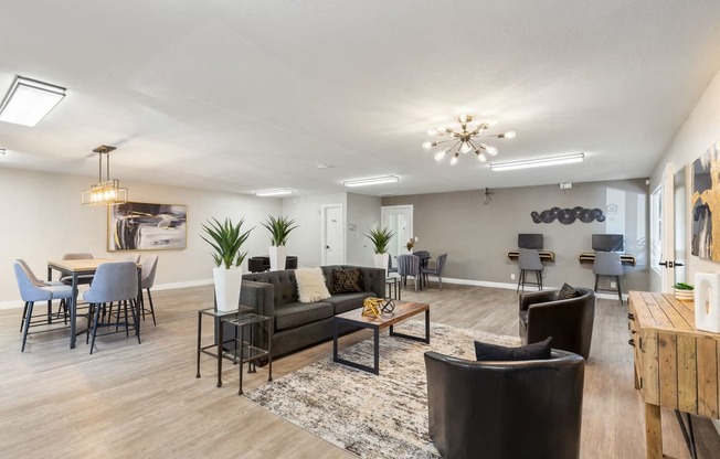 a living room with couches and chairs and a dining room table at Acacia Gardens, Albuquerque, NM