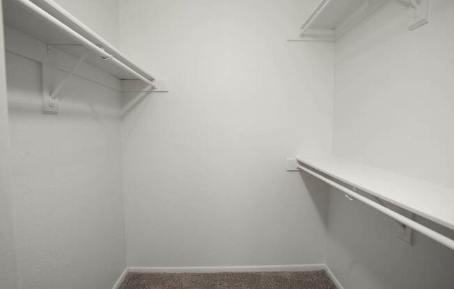 A white room with a carpeted floor and white walls.