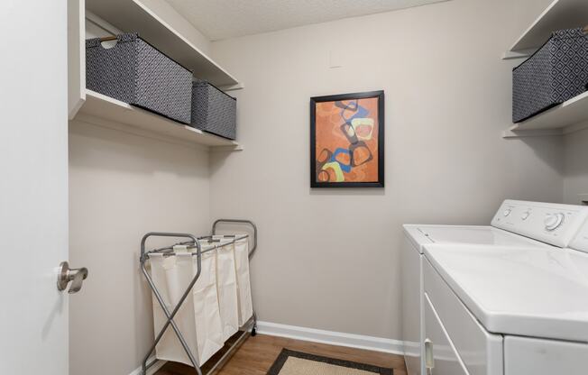 private laundry room with washer and dryer at the enclave at woodbridge apartments