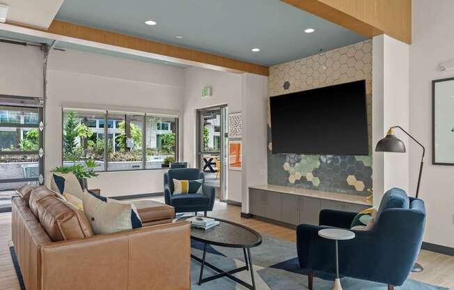 A modern living room with a brown leather couch and a black chair.