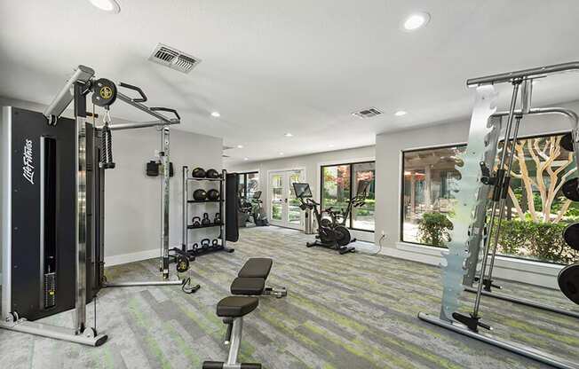 Community Fitness Center with Equipment at Bridges at Deer Run Apartments in Dallas, TX.