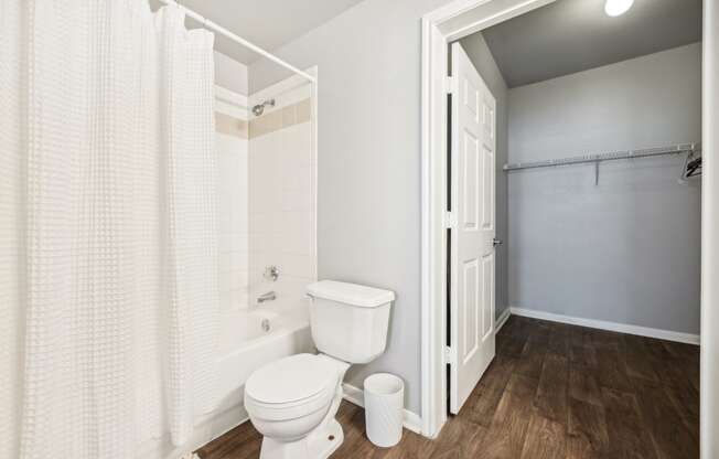 a bathroom with a toilet and a shower with a curtain