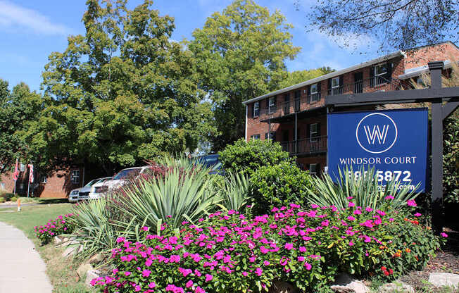 A sign for Windsor Court is in front of a building.