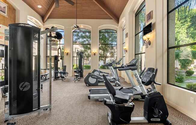 A gym with treadmills, elliptical machines, and other exercise equipment.