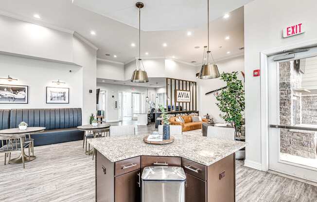 a kitchen with an island and a living room in the background