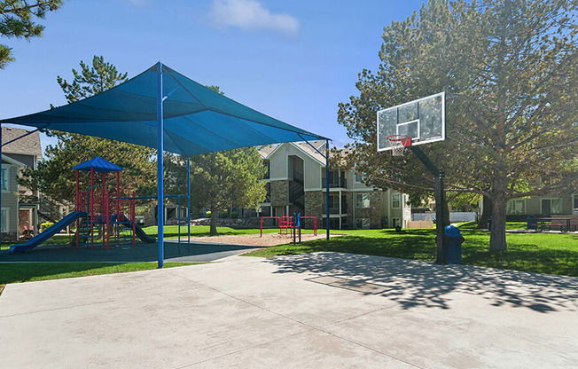 Community Sports Court and Playground Area at Broadmoor Village Apartments located in West Jordan, UT.