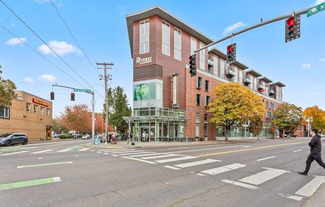 A man is crossing the street at a crosswalk.