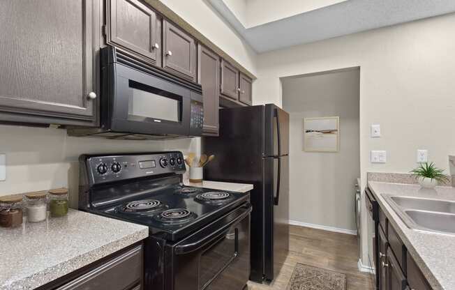 a kitchen with black appliances and black refrigerator