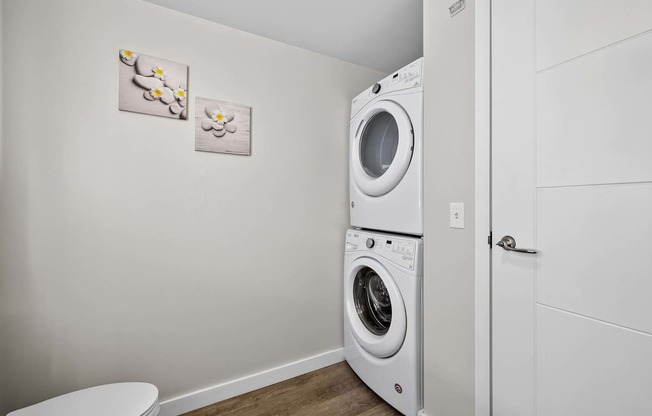 A white washing machine and dryer in a small laundry room.