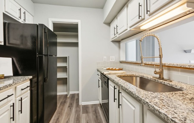 a kitchen with granite counter tops and stainless steel appliances