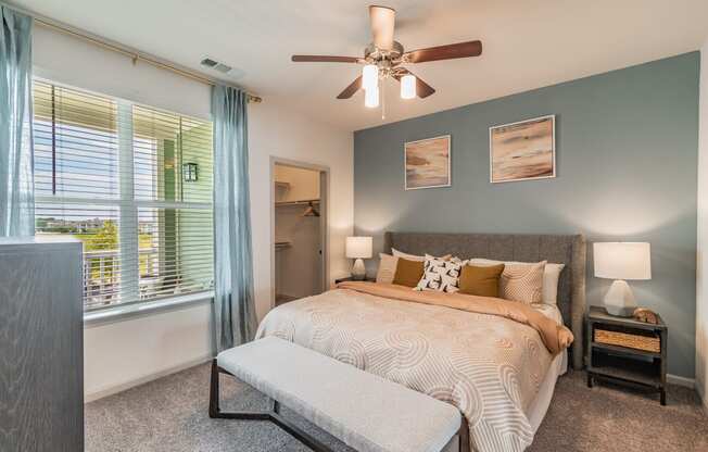 Bedroom With Large Windows & Built-In Window Treatments