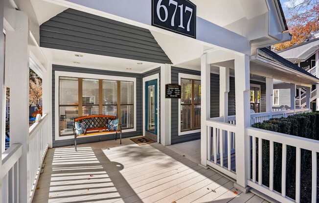 The image shows a house entrance with a number 6717 on the signboard.