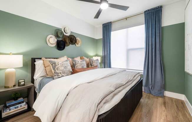 a bedroom with a bed and a ceiling fan