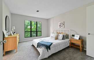 a bedroom with a bed and a dresser