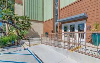 the front of a building with steps and a fence