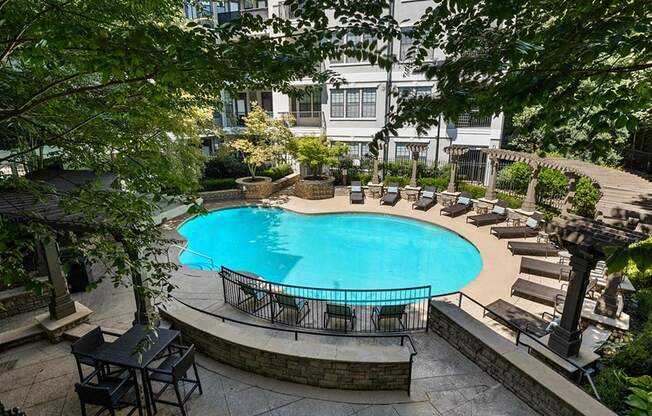 a large swimming pool in front of a hotel