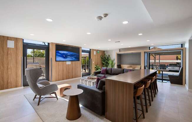 a kitchen and living room with a bar and a television