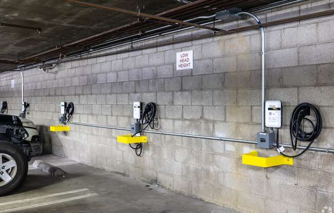 A wall of electrical outlets and a sign that says low head height.