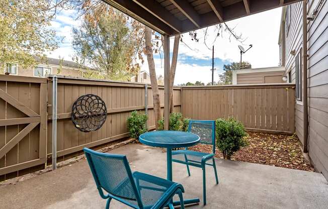 A patio with a table and two chairs.
