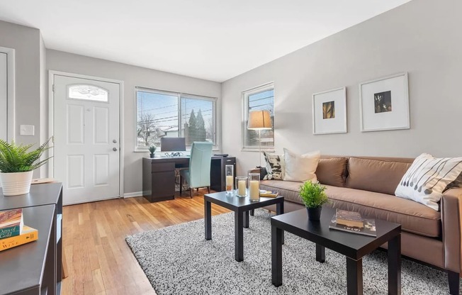 a living room with a couch and tables