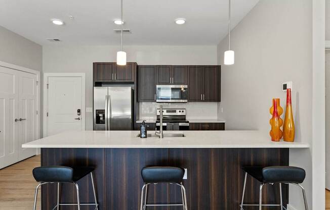 A modern kitchen with a bar stool.